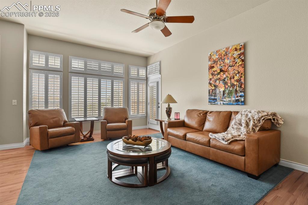 617 Concerto Drive Colorado Springs, CO 80906 - Photo 14 of 46 Another view of the Living area showing the bank of windows and the door to the covered deck.