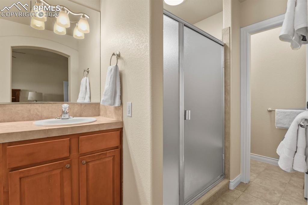 617 Concerto Drive Colorado Springs, CO 80906 - Photo 19 of 46 Featuring a double vanity, wooden cabinetry, a separate large shower and the separate toilet room.