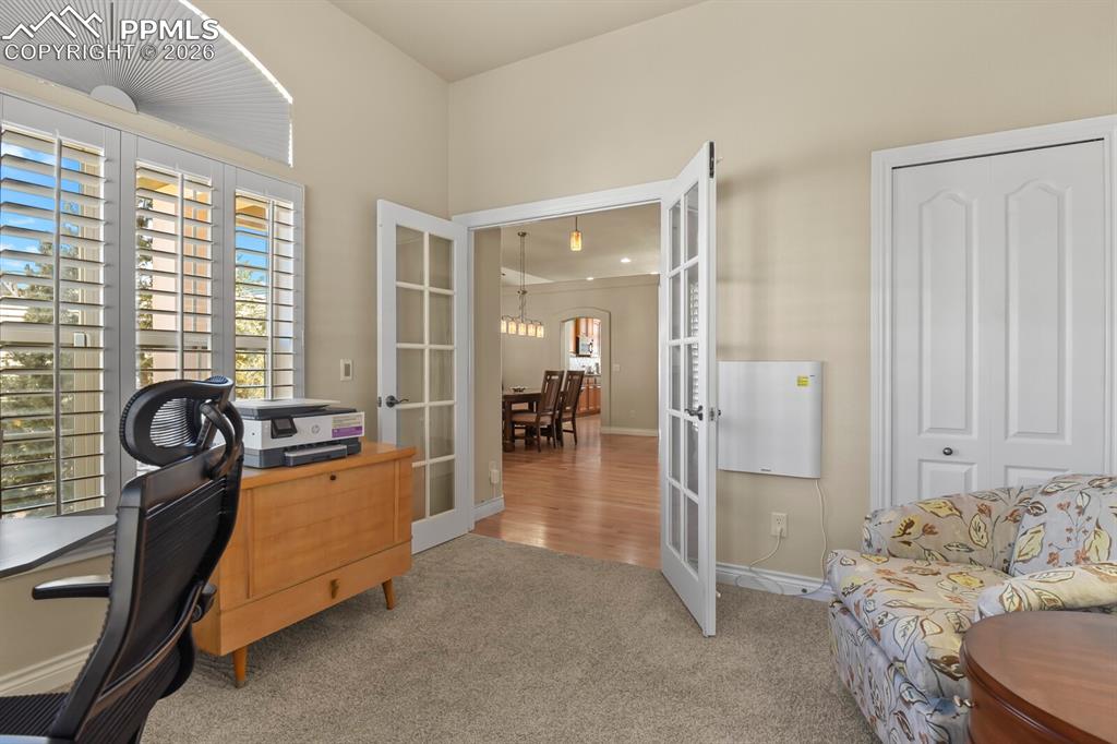 617 Concerto Drive Colorado Springs, CO 80906 - Photo 23 of 46 This versatile room features carpeted flooring, a large window with plantation shutters, and French doors. Currently used as an office but is the second bedroom on the main floor.