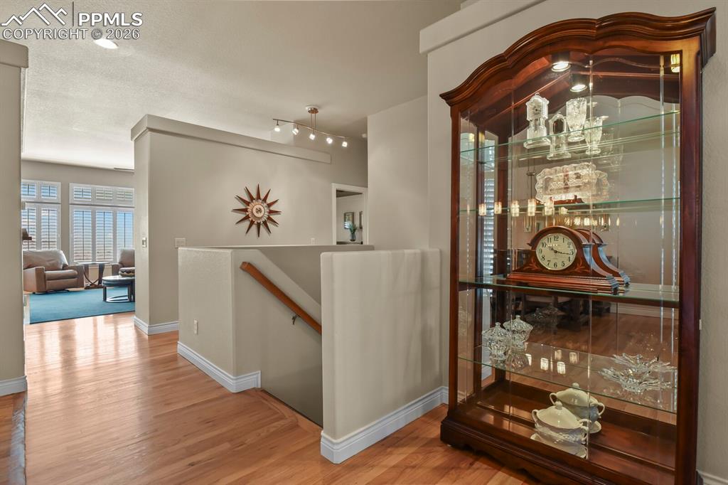 617 Concerto Drive Colorado Springs, CO 80906 - Photo 26 of 46 Showing the staircase with a wooden handrail and attractive and easy clean part tile and part wood stairs.