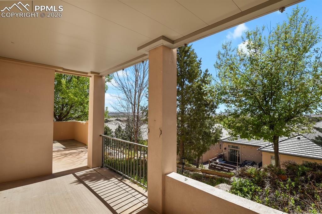617 Concerto Drive Colorado Springs, CO 80906 - Photo 40 of 46 The property features a second covered patio with a concrete floor and metal railings accessed through the basement walkout.