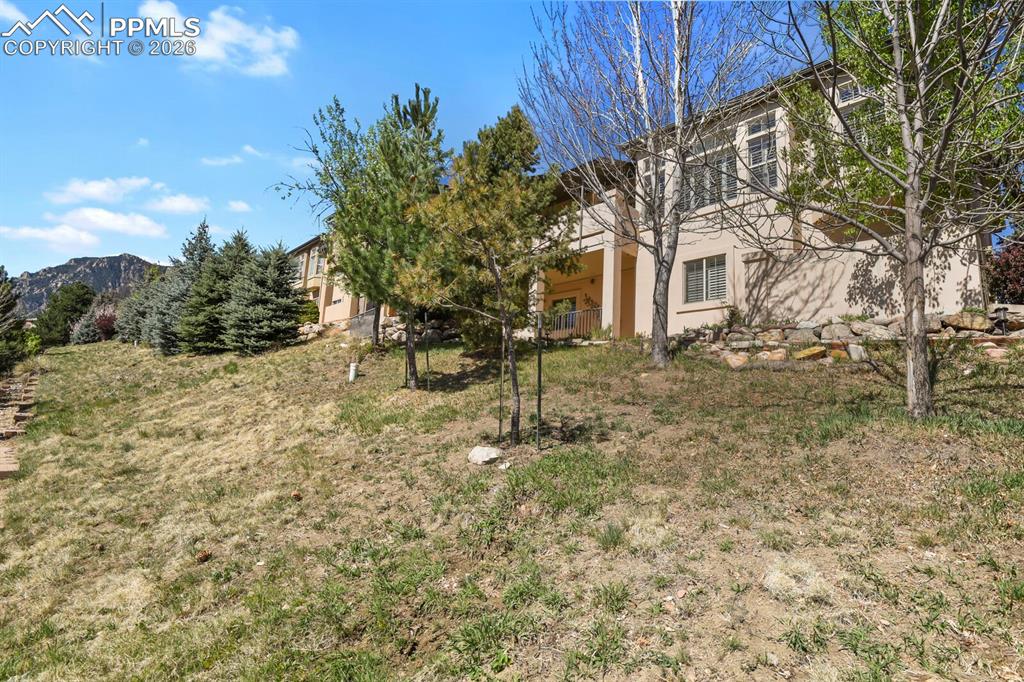 617 Concerto Drive Colorado Springs, CO 80906 - Photo 41 of 46 Showing the back of this spacious stucco ranch home. Some mountain views.