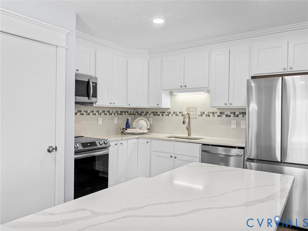 1339 Harris Creek Road Louisa, VA 23093 - Photo 15 of 46 a kitchen with stainless steel appliances a stove sink and refrigerator