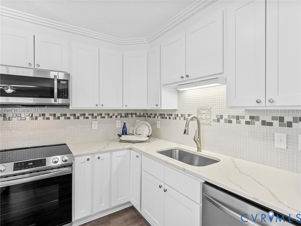 1339 Harris Creek Road Louisa, VA 23093 - Photo 16 of 46 a kitchen with granite countertop white cabinets and stainless steel appliances