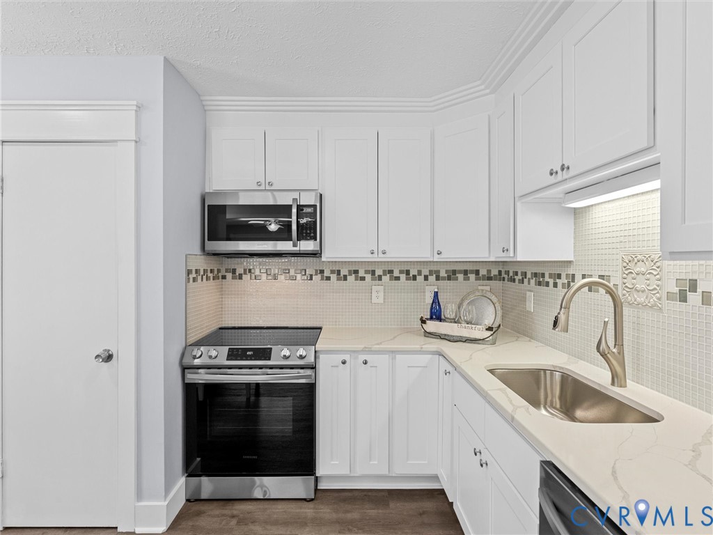 1339 Harris Creek Road Louisa, VA 23093 - Photo 17 of 46 a kitchen with stainless steel appliances granite countertop a sink dishwasher a stove and a microwave oven with cabinets