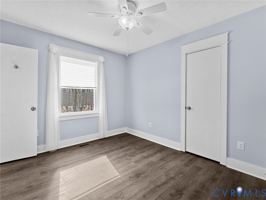 1339 Harris Creek Road Louisa, VA 23093 - Photo 21 of 46 a view of an empty room with a window and wooden floor