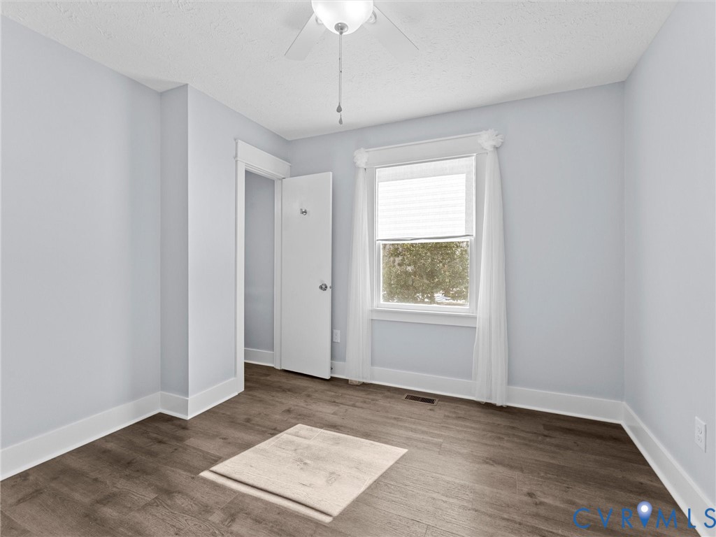 1339 Harris Creek Road Louisa, VA 23093 - Photo 23 of 46 an empty room with wooden floor cabinet and windows