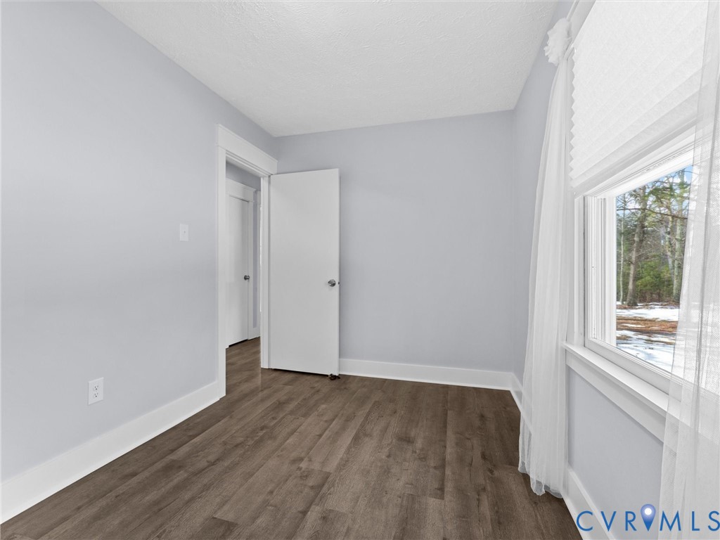 1339 Harris Creek Road Louisa, VA 23093 - Photo 26 of 46 a view of an empty room with wooden floor and a window