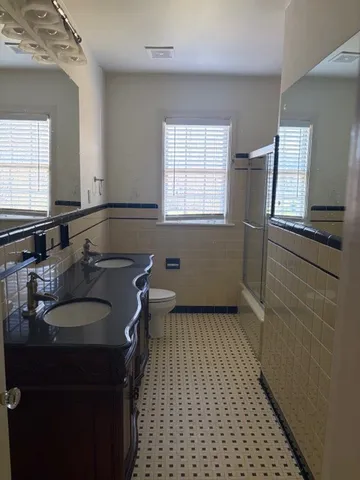 a bathroom with a sink a toilet and a window