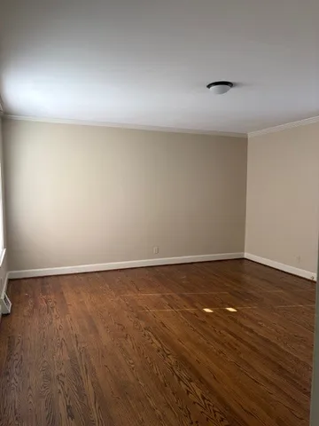 a view of an empty room and wooden floor