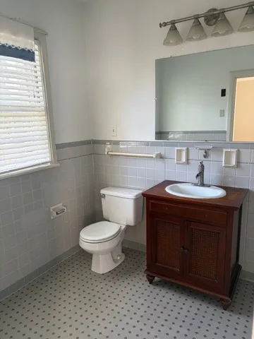a bathroom with a sink toilet and mirror