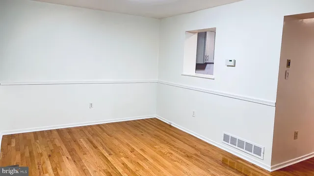 a view of a room with wooden floor