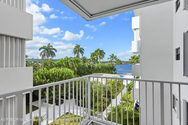 a view of a balcony with wooden fence