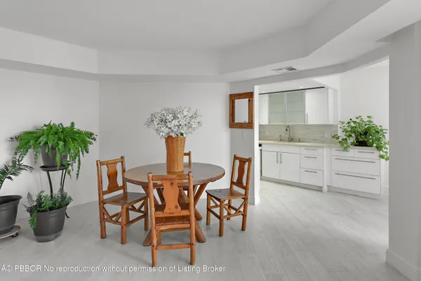 a view of a dining room with furniture and a potted plant