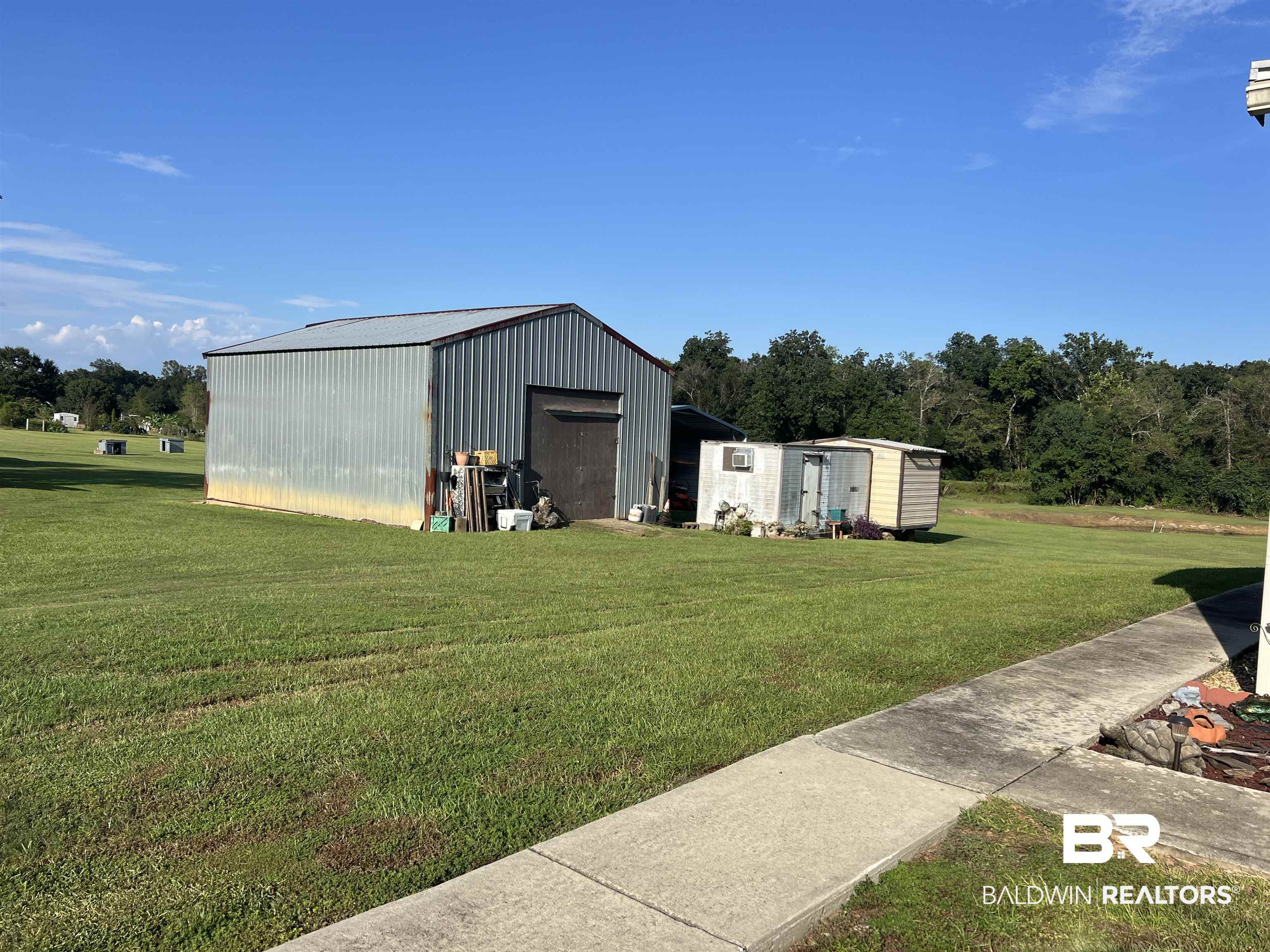 16824 Underwood Road Foley, AL 36535 - Photo 5 of 25 View of outdoor structure featuring a lawn