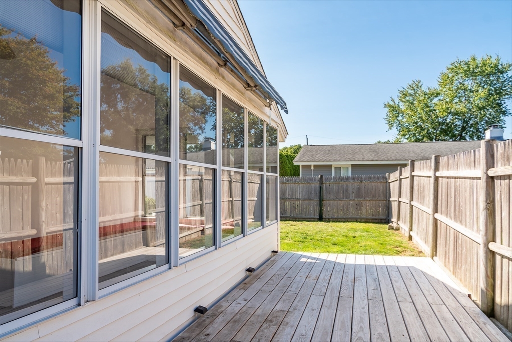 14 Rosslare Road Framingham, MA 01701 - Photo 18 of 20 a view of backyard with a small deck and wooden floor