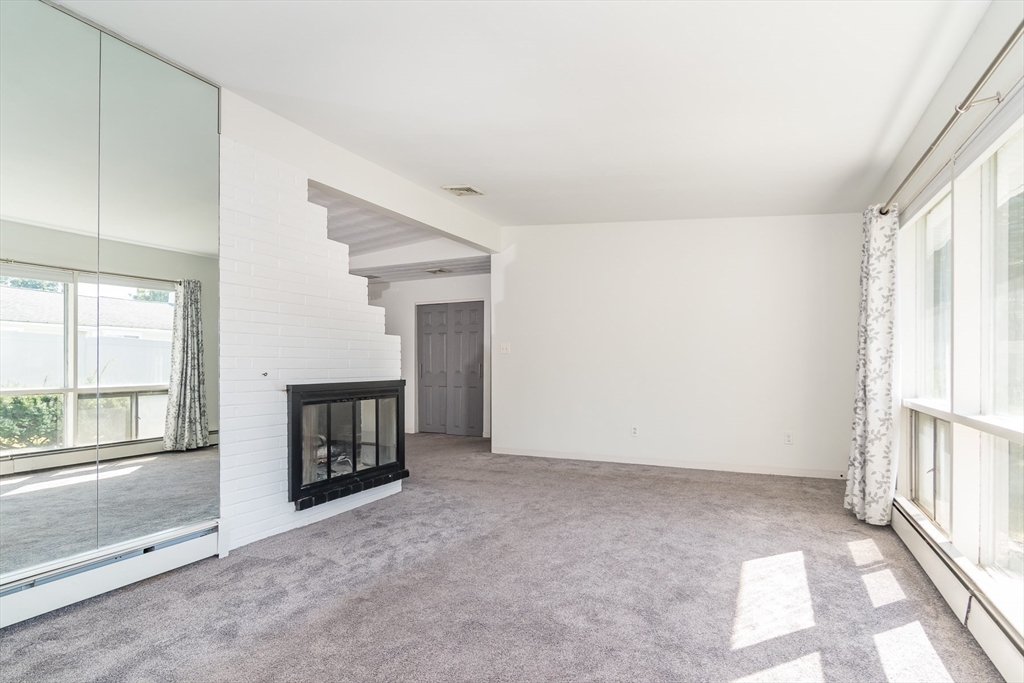 14 Rosslare Road Framingham, MA 01701 - Photo 8 of 20 an empty room with fireplace and windows