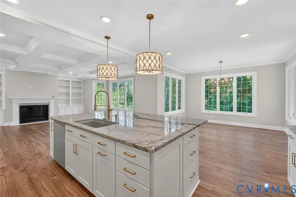 a kitchen with granite countertop a stove and a wooden floors