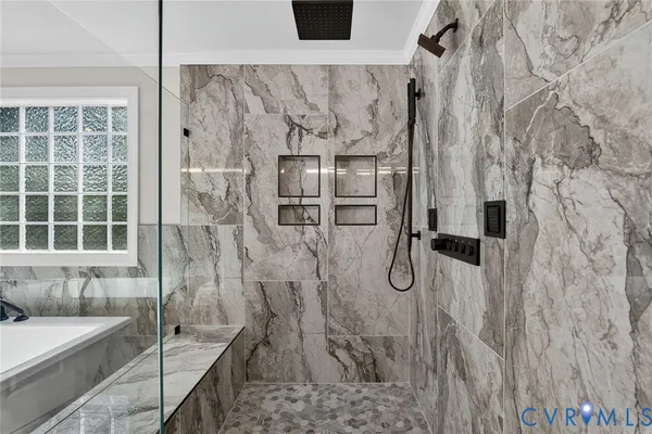a bathroom with a bathtub and shower
