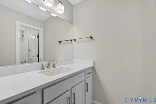 a bathroom with a sink a vanity and a mirror