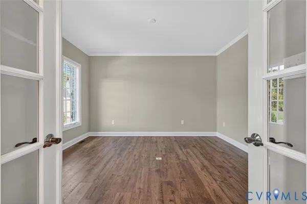 a view of a room with wooden floor and a window