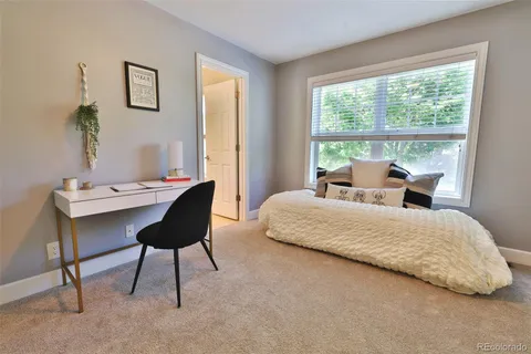 a bedroom with a bed and a table