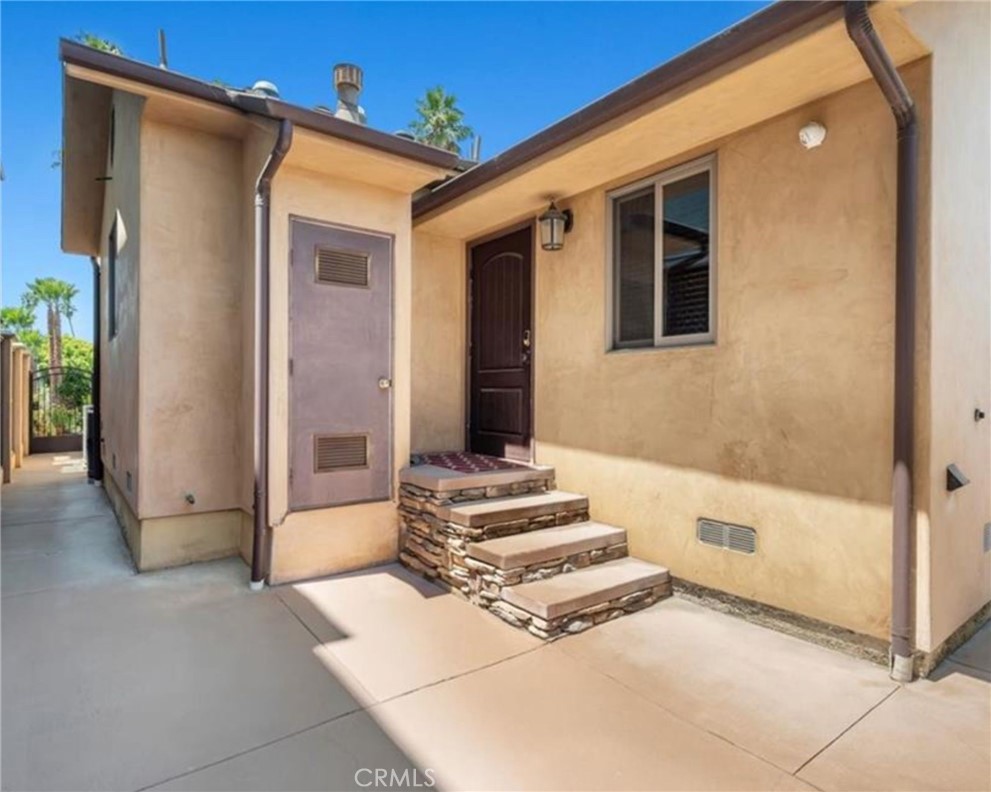 116 Termino Avenue Long Beach, CA 90803 - Photo 45 of 67 Side door off laundry room, note the quality of the colored concrete matching the stone.