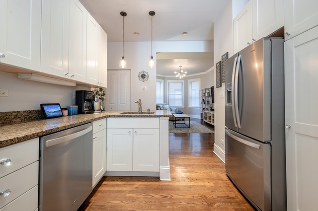 665 West Barry Avenue, Unit 2S Chicago, IL 60657 - Photo 4 of 10 a kitchen with a refrigerator a sink and cabinets