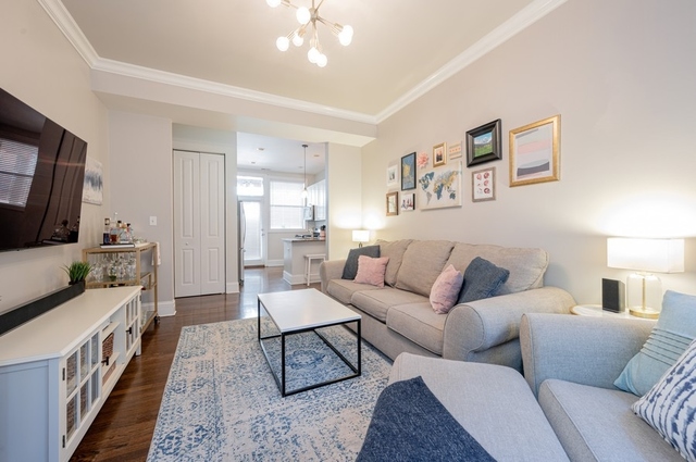 665 West Barry Avenue, Unit 2S Chicago, IL 60657 - Photo 5 of 10 a living room with furniture and a flat screen tv