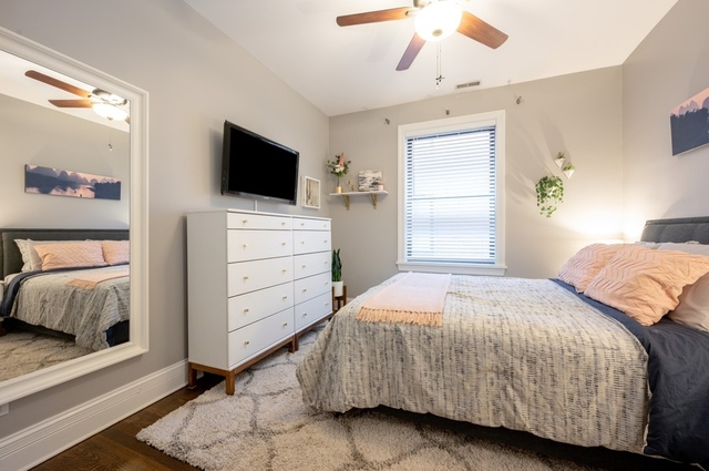 665 West Barry Avenue, Unit 2S Chicago, IL 60657 - Photo 6 of 10 a bedroom with a bed and flat screen tv