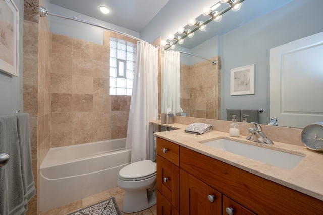 665 West Barry Avenue, Unit 2S Chicago, IL 60657 - Photo 8 of 10 a bathroom with a sink a toilet and shower