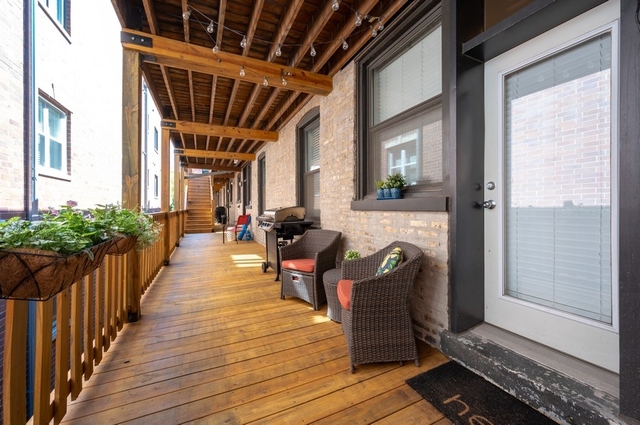 665 West Barry Avenue, Unit 2S Chicago, IL 60657 - Photo 10 of 10 a view of a porch with furniture and wooden floor