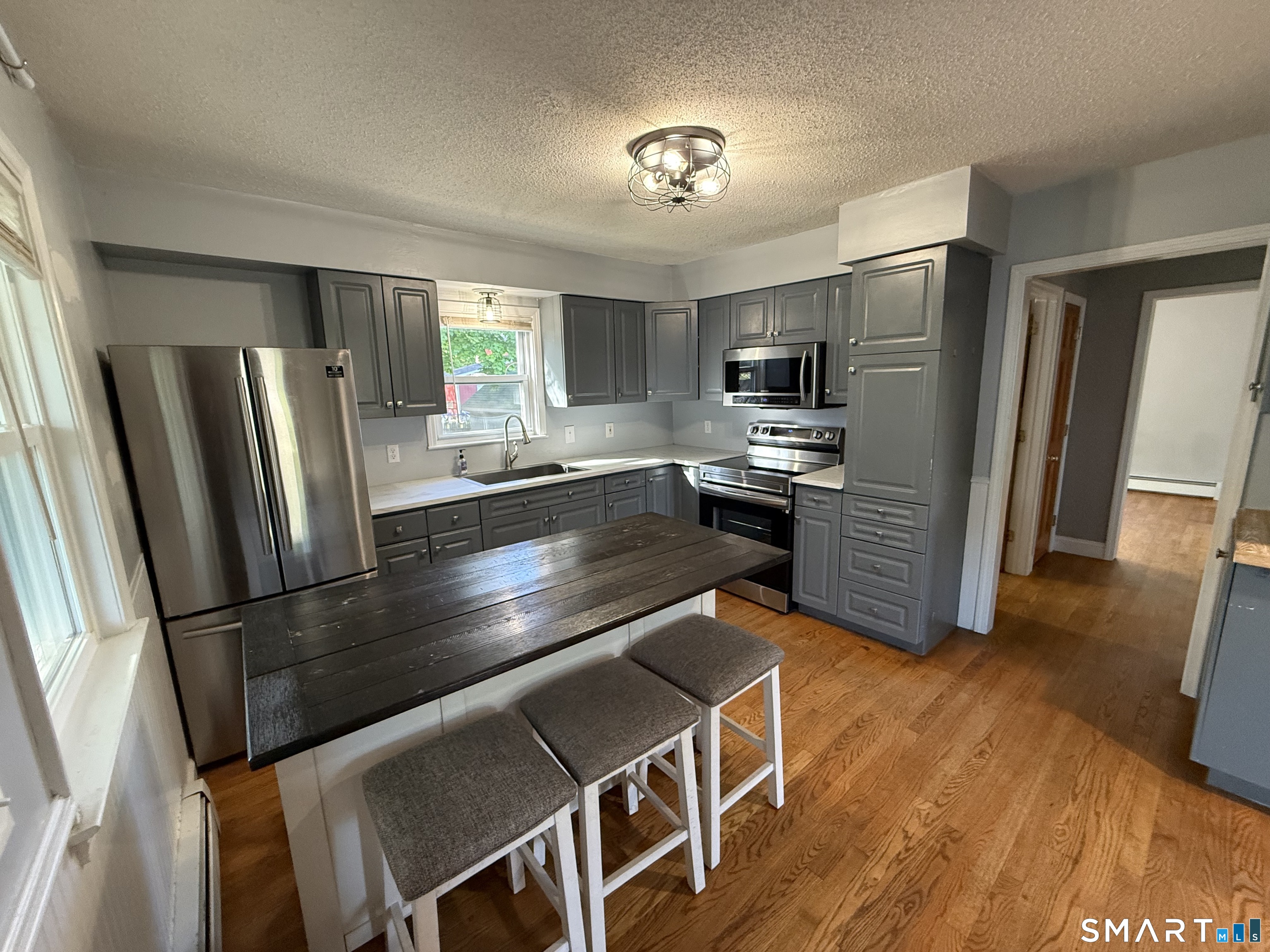 808 East Main Street Torrington, CT 06790 - Photo 12 of 40 a kitchen with stainless steel appliances granite countertop a refrigerator stove and sink