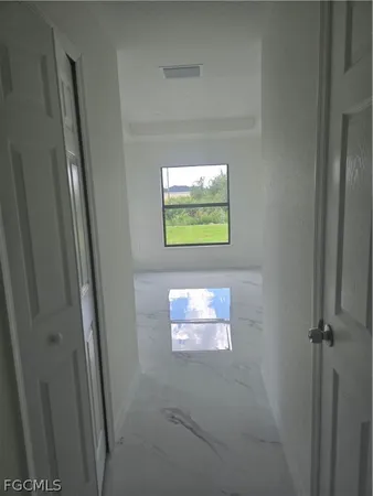 an empty room with windows and closet