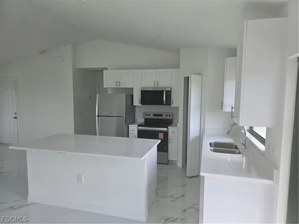 a kitchen with a refrigerator and a sink