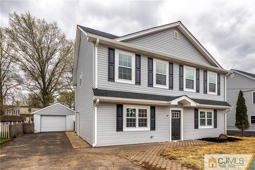87 Ashley Road Edison, NJ 08817 - Photo 1 of 35 a front view of a house with a yard and garage