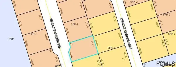 a street sign on a tree in front of a house