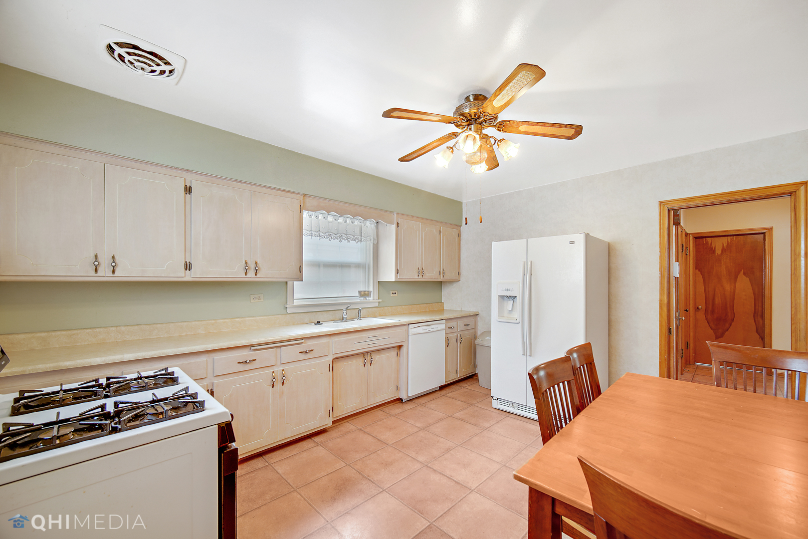 1442 Ridge Road Homewood, IL 60430 - Photo 12 of 25 a kitchen with stainless steel appliances a stove a sink dishwasher and a refrigerator