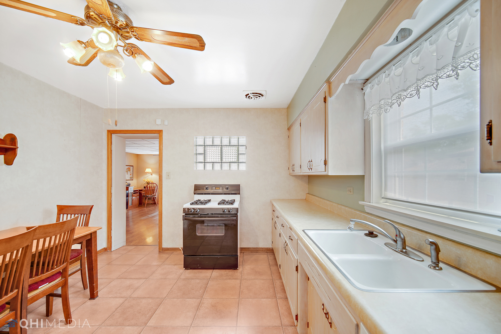 1442 Ridge Road Homewood, IL 60430 - Photo 14 of 25 a kitchen with stainless steel appliances granite countertop a sink dishwasher and a refrigerator with wooden floor