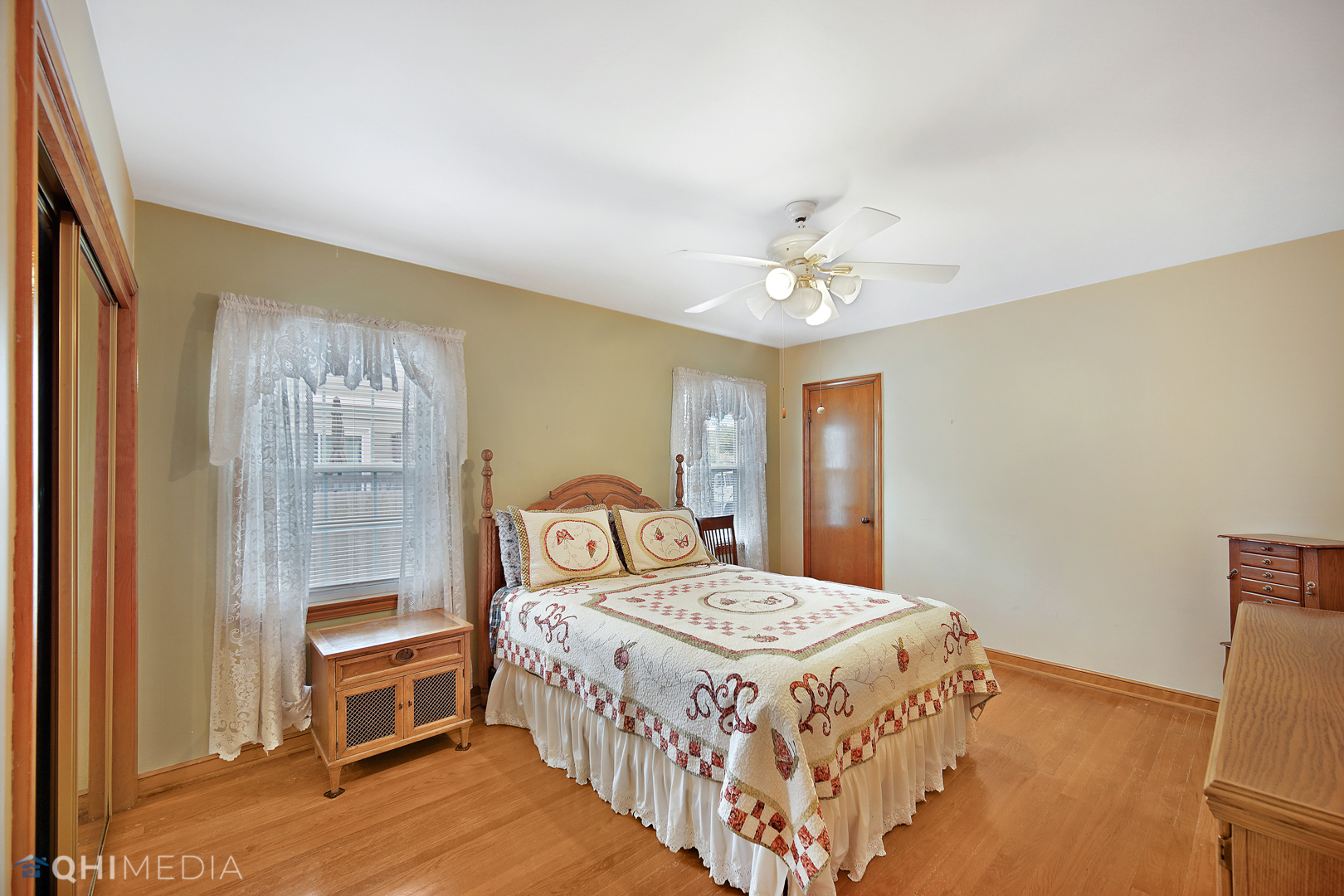 1442 Ridge Road Homewood, IL 60430 - Photo 15 of 25 a bedroom with a bed and a chandelier