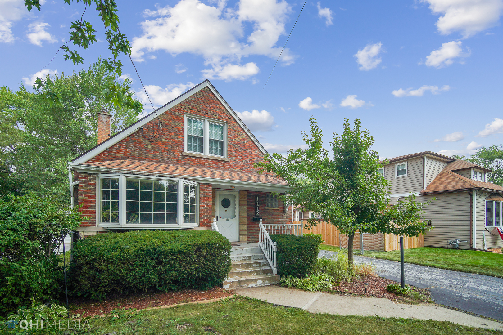 1442 Ridge Road Homewood, IL 60430 - Photo 4 of 25 a front view of a house with a yard and potted plants