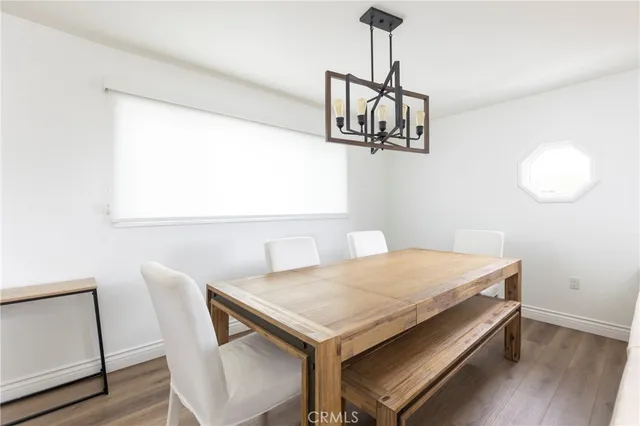 a view of a dining room with a table and chairs
