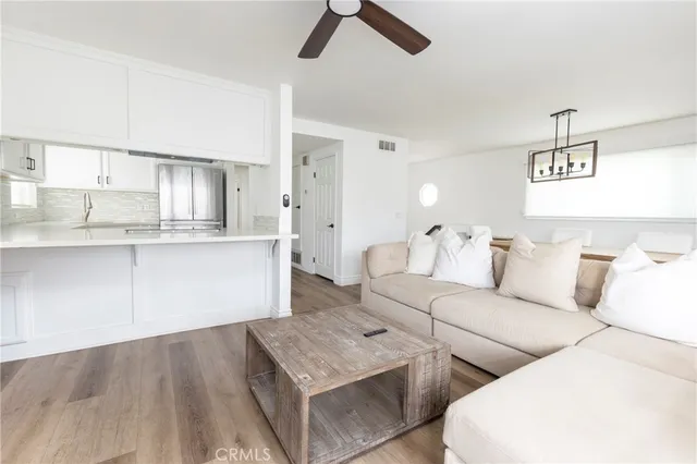 a living room with furniture and a kitchen view