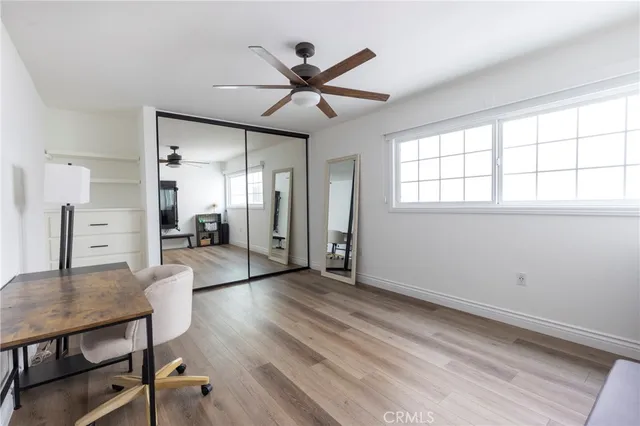 a view of a livingroom with a window and wooden floor