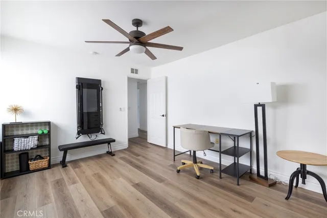 a view of a livingroom with furniture and a workspace