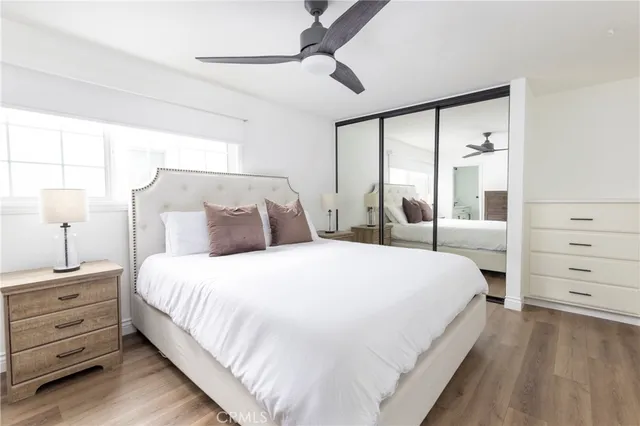 a large bed sitting in a bedroom next to a window