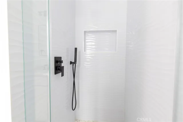 a bathroom with a glass shower door