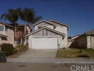 1997 West Cluster Pine Road Colton, CA 92324 - Photo 1 of 1 a front view of a house with garden