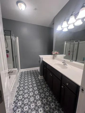 a bathroom with a double vanity sink and a mirror