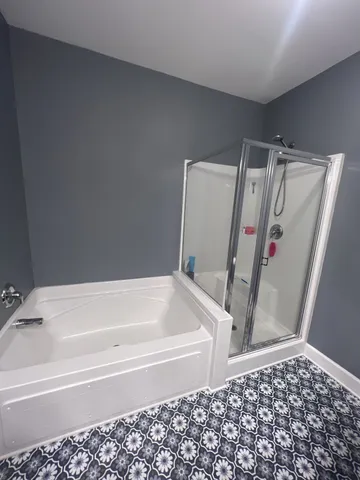 a bathroom with a bathtub and a shower